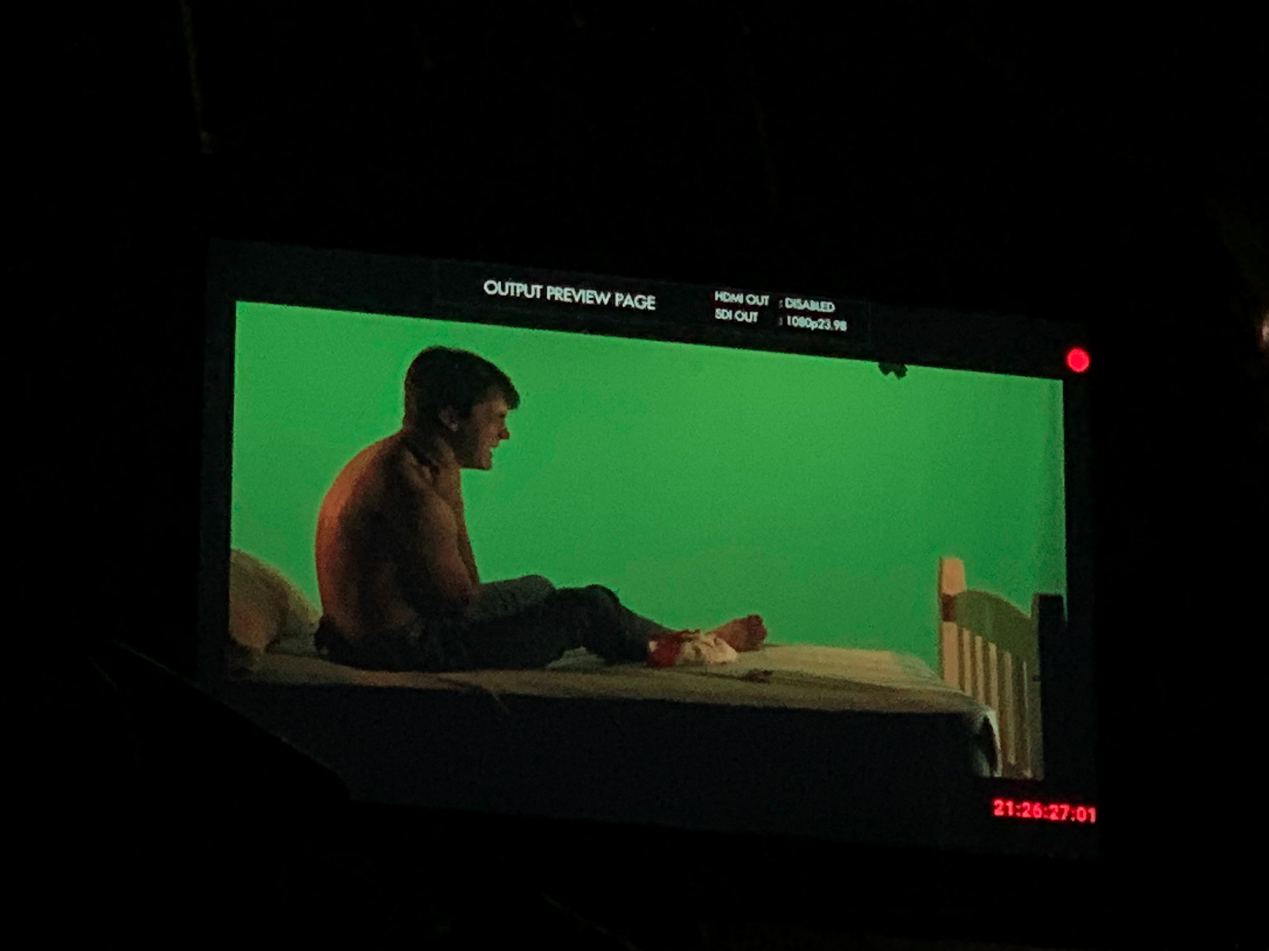 Camera monitor showing an actor against green screen